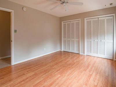An empty, spacious room with natural light, ready for a workout.